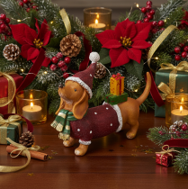 Artículo Figura decorativa de perro salchicha con paquete de regalo y sombrero, 18 cm.
