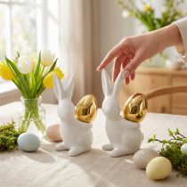 Artículo Conejos con huevo de oro, conejos de cerámica para Pascua blanco noble, dorado H13cm 2pcs