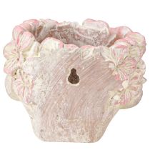 Artículo Maceta colgante con forma de cabeza de planta, aspecto hormigón, color rosa, altura 13 cm.