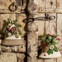 Artículo Decoración rústica de pared con campanas navideñas, ramas de abeto de yute y piñas.