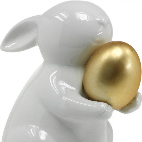 Floristik24 Conejo con huevo de oro de cerámica, decoración de Pascua blanco elegante, dorado Al. 15 cm