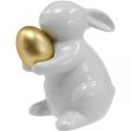 Floristik24 Conejo con huevo de oro de cerámica, decoración de Pascua blanco elegante, dorado Al. 15 cm